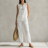 White FJØRNA two-piece women's co-ord set with V-neck top and matching pants featuring pockets, stylish and comfortable.