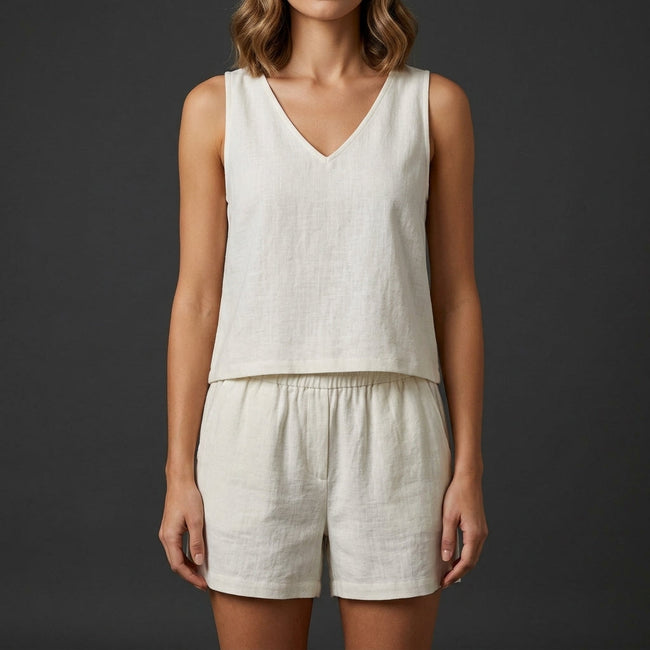 White FJØRNA women's summer two-piece pleated V-neck co-ord set featuring a stylish top and matching skirt.