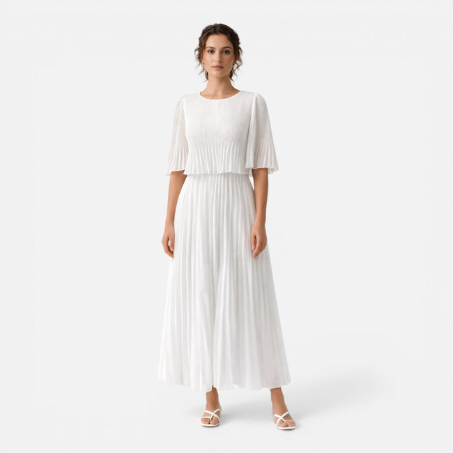 Women's white chiffon pleated maxi dress by FJØRNA, flowing design with pleats, suitable for wedding guests.