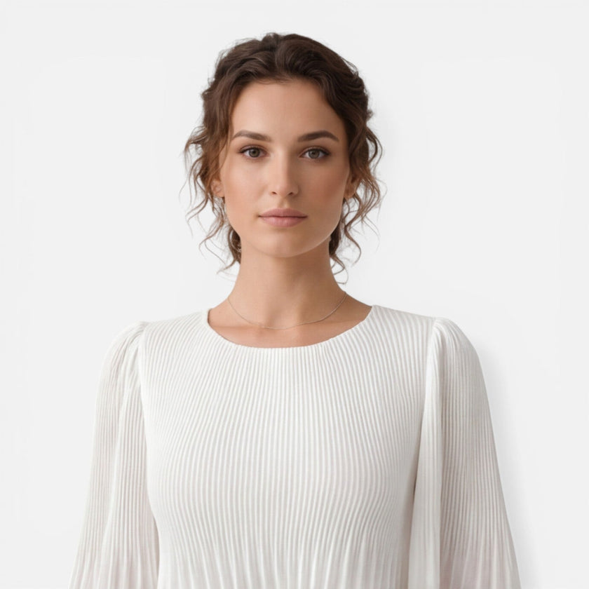 Women's white chiffon pleated maxi dress by FJØRNA, flowing design with pleats, suitable for wedding guests.