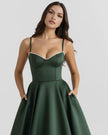 Woman wearing FJØRNA women's corset midi dress with a layered tulle skirt, showcasing elegant evening wear.