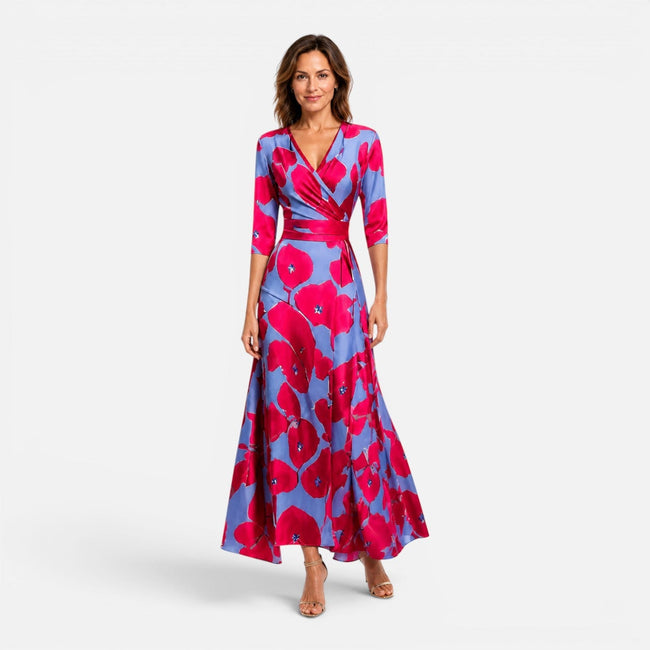Women’s floral wrap maxi dress with an elegant V-neck silhouette by FJØRNA, shown on a model in a stylish outdoor setting.
