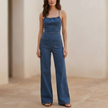 FJØRNA women's wide-leg denim jumpsuit with tie-back detail, featuring a relaxed fit and stylish design perfect for casual wear.