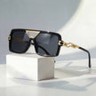 Women's retro square sunglasses by FJØRNA with gold chain link detail and UV protection, stylish eyewear for sunny days.