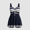 Women's FJØRNA nautical print swim dress with a fitted bodice and skirted hem, perfect for beach or poolside wear.