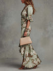 FJØRNA Kassy White Dress, a long elegant dress with flowing fabric and delicate details, perfect for formal occasions.