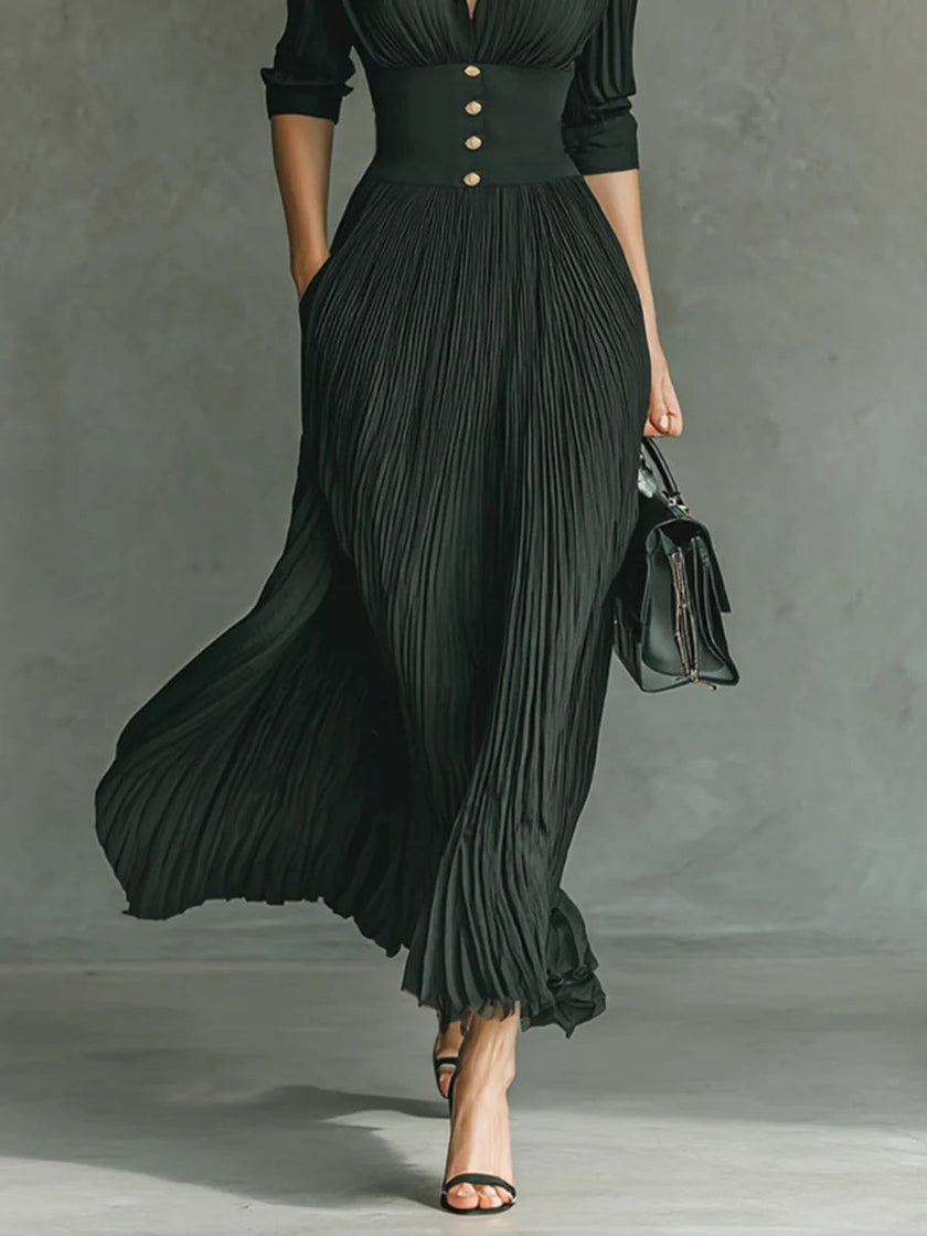 Elegant FJØRNA women's maxi dress with V-neck and pleated design, flowing fabric perfect for formal or casual occasions.