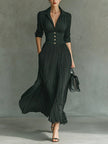 Elegant FJØRNA women's maxi dress with V-neck and pleated design, featuring a flowing silhouette and soft fabric.