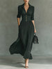 Elegant FJØRNA women's maxi dress with V-neck and pleated design, featuring a flowing silhouette and soft fabric.