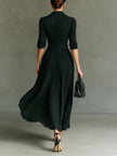 FJØRNA elegant women's maxi dress with V-neck and pleated design, featuring a flowing silhouette and sophisticated style.