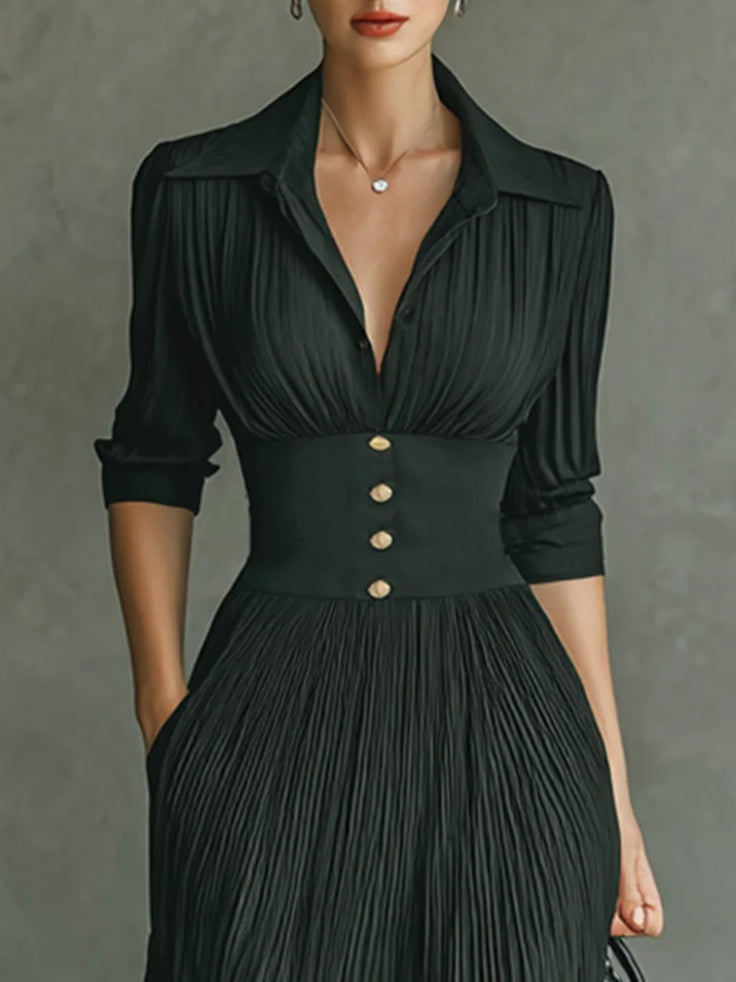 Elegant FJØRNA women's maxi dress with V-neck and pleated design, featuring flowing fabric and a sophisticated silhouette.