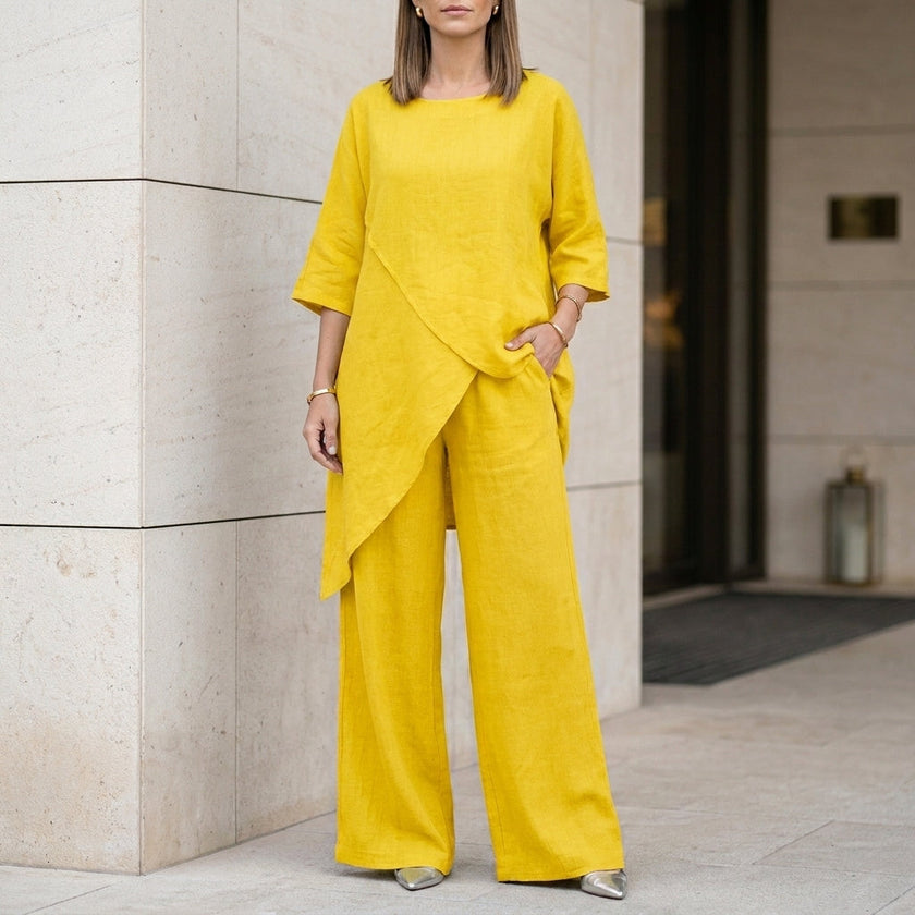 Yellow women's summer two-piece co-ord set with asymmetric design, from FJØRNA, featuring a stylish and comfortable matching top and bottom.
