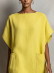 FJØRNA yellow linen dress for women, lightweight and breezy, featuring a relaxed fit and natural fabric for casual summer wear.