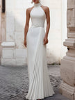 White satin pleated halter evening gown by FJØRNA, elegant dress with a flowing design for formal black tie events.