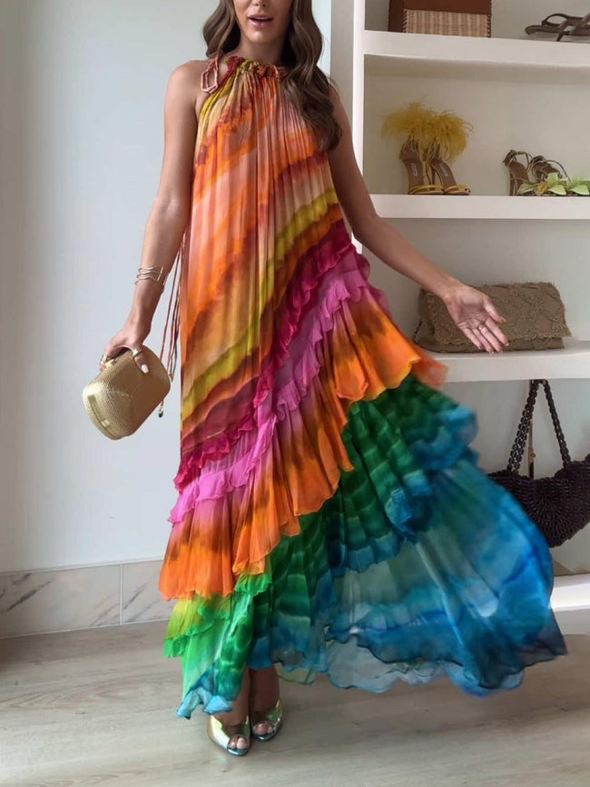 Colorful print ruffle maxi dress for women by FJØRNA, perfect for summer, featuring vibrant patterns and flowing fabric.