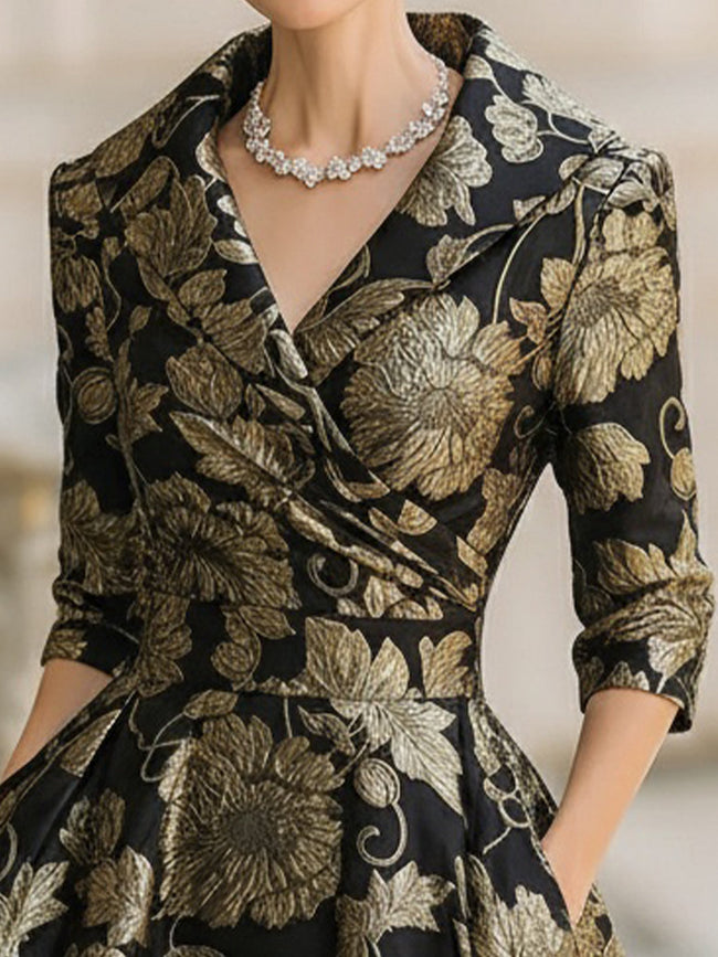 FJØRNA black and gold floral jacquard midi dress with a fitted waist and elegant design, perfect for formal occasions.