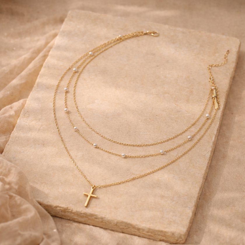 Gold 3-layer pearl pendant necklace set for women, layered jewelry accessory by FJØRNA featuring multiple pearl-adorned chains.