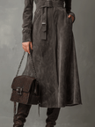FJØRNA high neck belted suede midi dress featuring a fitted silhouette and elegant design, shown on a model.