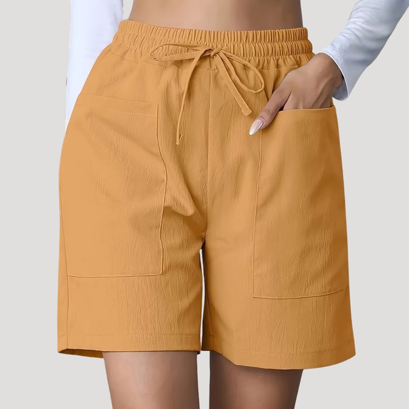 FJØRNA women's lightweight summer shorts with wide legs, drawstring waist, and pocket details, perfect for casual warm-weather wear.