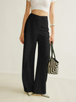 FJØRNA women's lightweight summer trousers with wide legs, high waist, and asymmetric wrap design.