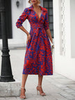 White FJØRNA elegant shirt dress displayed on a hanger, showcasing a classic collar, button front, and flowing fabric.