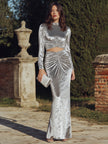 Black FJØRNA long sleeve ruched cutout evening gown with fitted silhouette, perfect for elegant formal occasions.
