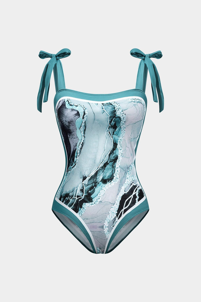 Women's abstract print swimsuit set with pareo from FJØRNA, featuring stylish strappy details and vibrant design.