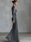 Grey knit ruched maxi dress by FJØRNA, showcasing a long evening dress with a fitted silhouette and ruched detailing.
