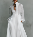 FJØRNA white maxi dress with stand collar, button details, and long sleeves, elegant and flowing for versatile occasions.