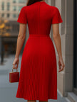 FJØRNA elegant red pleated midi dress for women, showcased on a model, featuring a sophisticated and flowing design.
