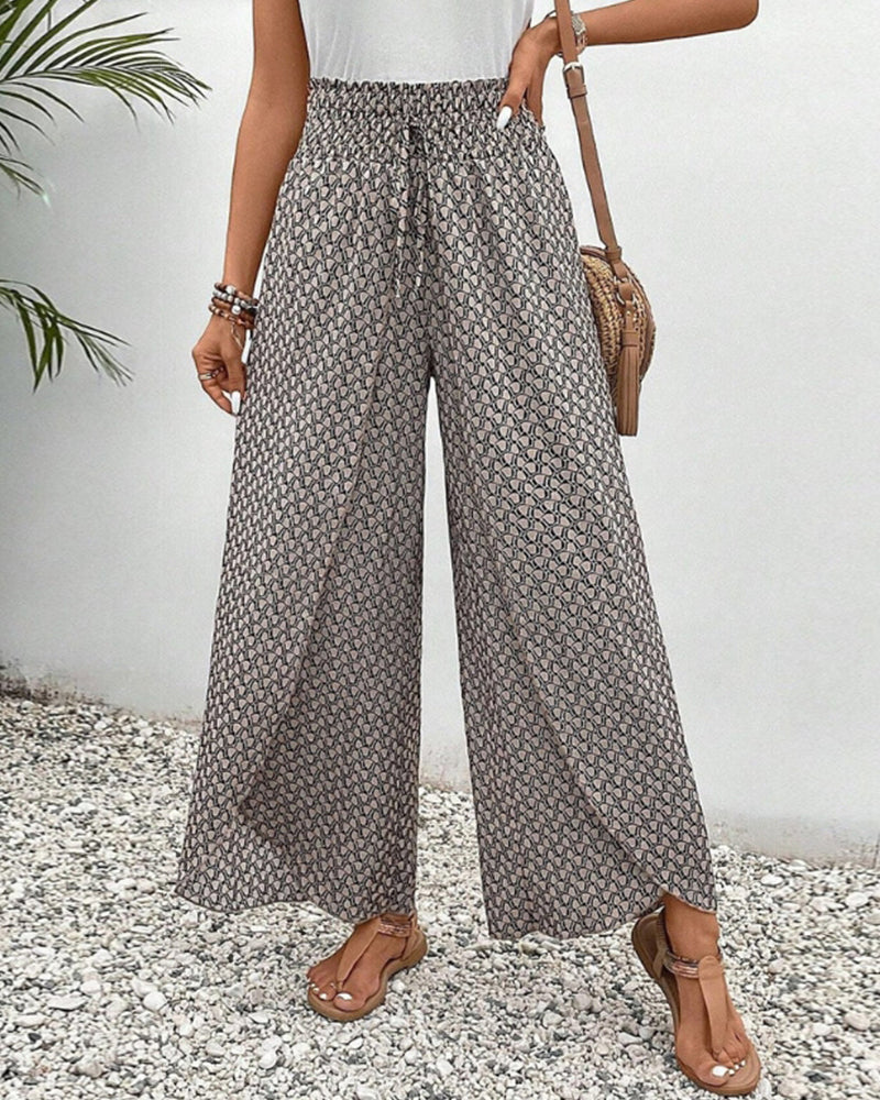 Beige FJØRNA women's lightweight summer trousers with wide leg fit and breathable fabric, perfect for warm weather.