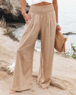 Beige lightweight summer women's trousers by FJØRNA featuring wide-leg design, perfect for beach and casual summer wear.