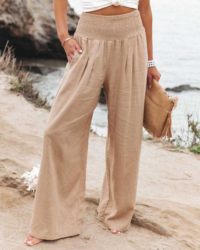 Beige lightweight summer women's trousers by FJØRNA featuring wide-leg design, perfect for beach and casual summer wear.