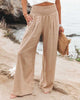 Beige lightweight summer women's trousers by FJØRNA featuring wide-leg design, perfect for beach and casual summer wear.