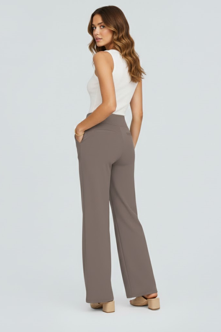 Lightweight high-waist wide-leg summer trousers for women by FJØRNA, with pockets and breathable fabric, styled on a model.