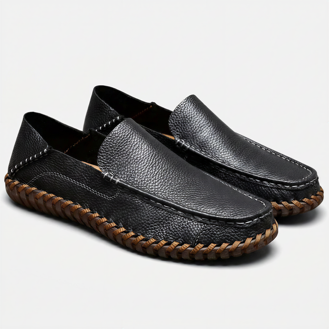Men's handstitched PU leather slip-on loafers by FJØRNA with round toe, perfect for smart casual style, shown in a natural pose.