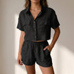 Black women's summer two-piece co-ord set by FJØRNA with relaxed fit and pockets, perfect for casual, warm-weather wear.