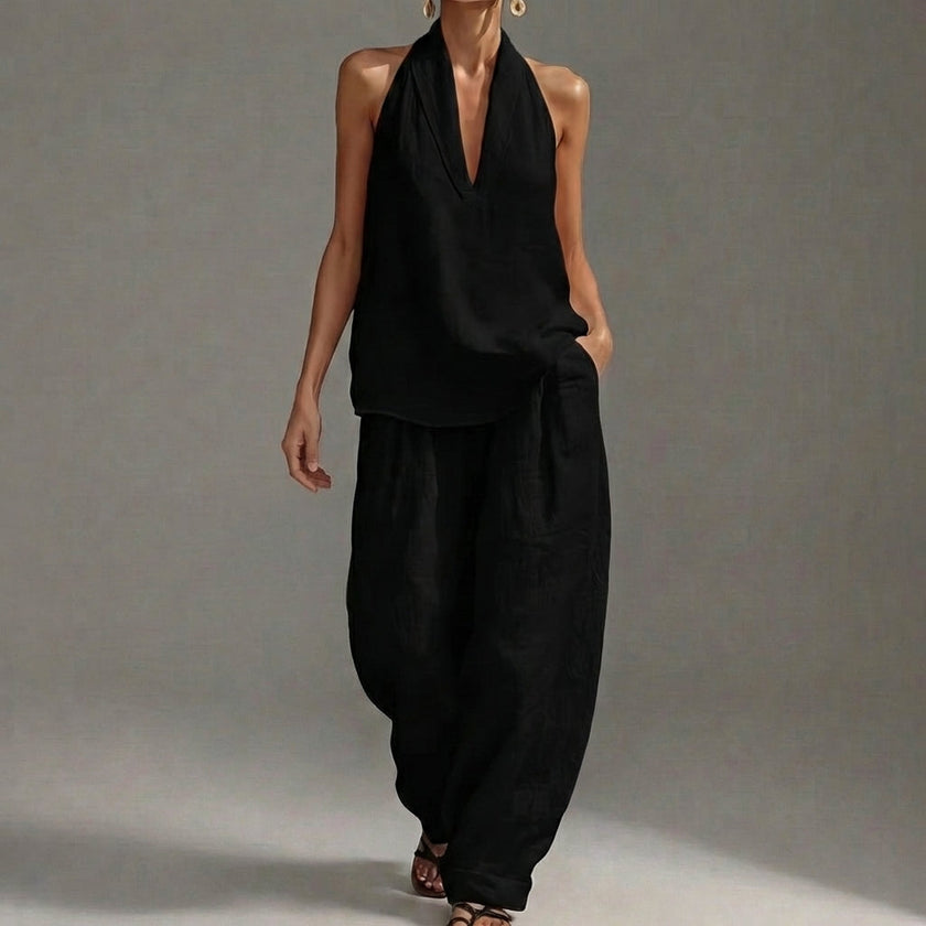 Black FJØRNA women's two-piece co-ord set with V-neck top and matching pants, featuring side pockets for a stylish summer look.