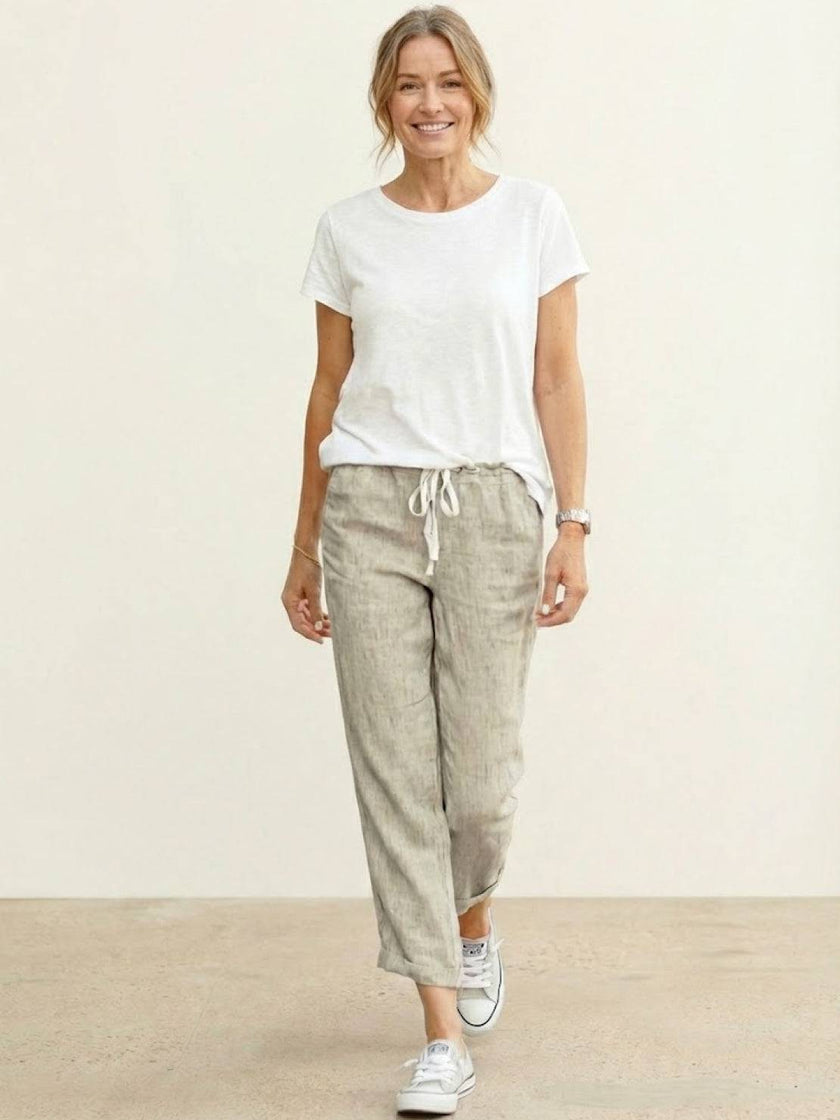FJØRNA women's linen summer trousers with a relaxed straight-leg fit and drawstring waist, ideal for casual warm-weather wear.