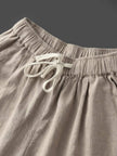 FJØRNA linen summer trousers for women with relaxed fit and straight leg design, featuring a drawstring waist and breathable fabric.