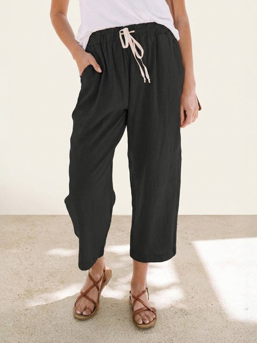FJØRNA women's linen summer trousers with a breezy relaxed fit and straight leg design, featuring a drawstring waist.