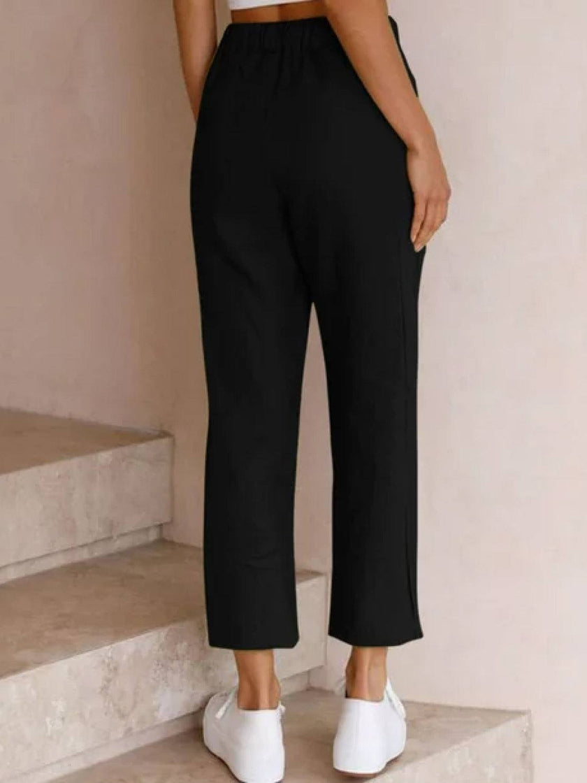 FJØRNA women's linen summer trousers with a relaxed, straight-leg fit and drawstring waist, ideal for breezy, comfortable style.