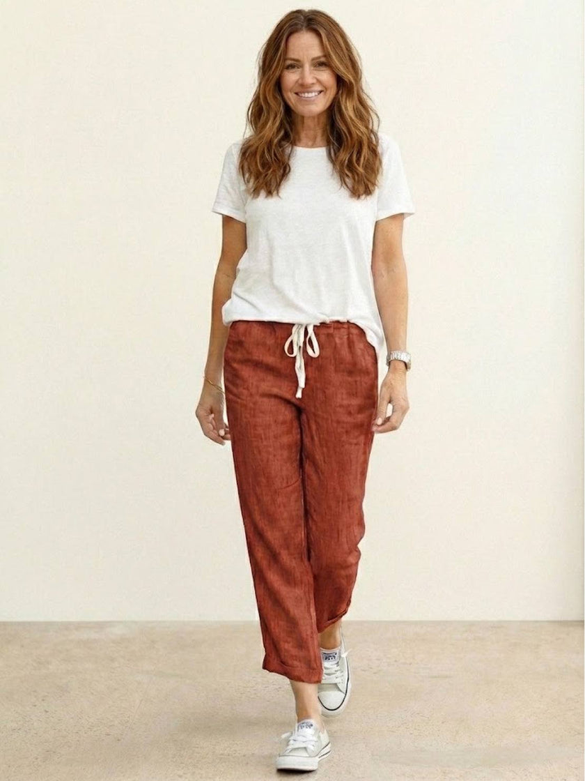 FJØRNA linen summer trousers for women with a breezy, relaxed fit and straight leg design, featuring a drawstring waist.