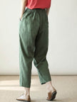 FJØRNA women's linen summer trousers with a relaxed straight-leg fit and drawstring waist, ideal for warm-weather casual wear.