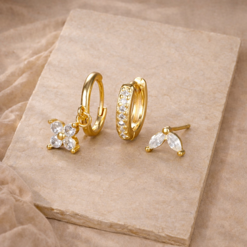 Unisex minimalist piercing set with stainless steel hoops and studs, featuring simple, elegant jewelry accessories for women.