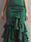 FJØRNA green satin tiered ruffle midi dress with ruffle hem, elegant and flowing, suitable for formal or semi-formal occasions.
