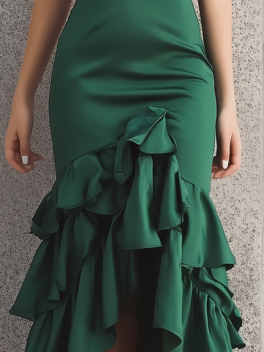 FJØRNA green satin tiered ruffle midi dress with ruffle hem, elegant and flowing, suitable for formal or semi-formal occasions.