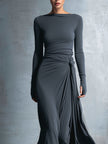 Grey knit wrap maxi dress for women by FJØRNA, featuring a flowing design and long sleeves, styled for casual or elegant occasions.