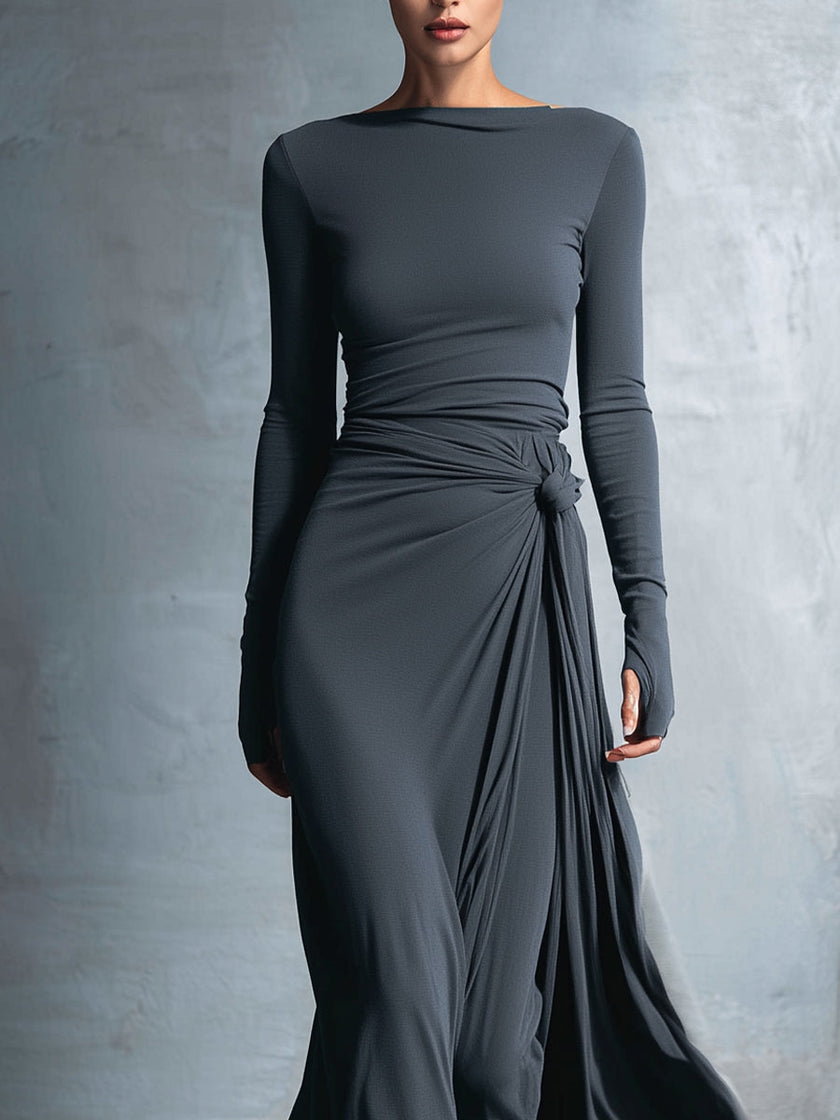 Grey knit wrap maxi dress for women by FJØRNA, featuring a flowing design and long sleeves, styled for casual or elegant occasions.