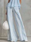 Light blue striped chiffon wide-leg women's pants by FJØRNA with flowing fabric and relaxed fit.